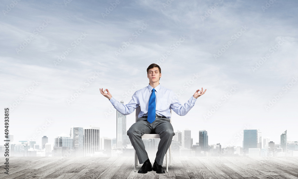 businessman meditates on office chair