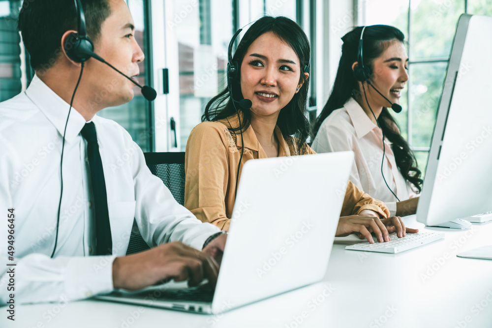 Business people wearing headset working actively in office . Call center, telemarketing, customer su