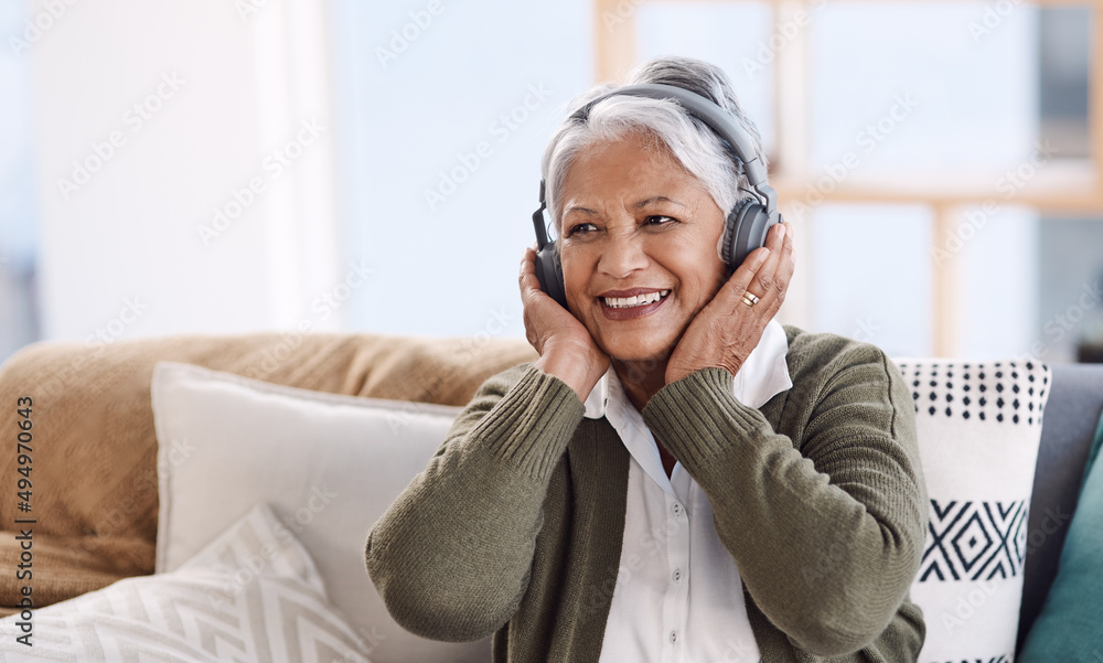 Some tunes will stay my favourite forever. Shot of a senior woman wearing headphones while listening