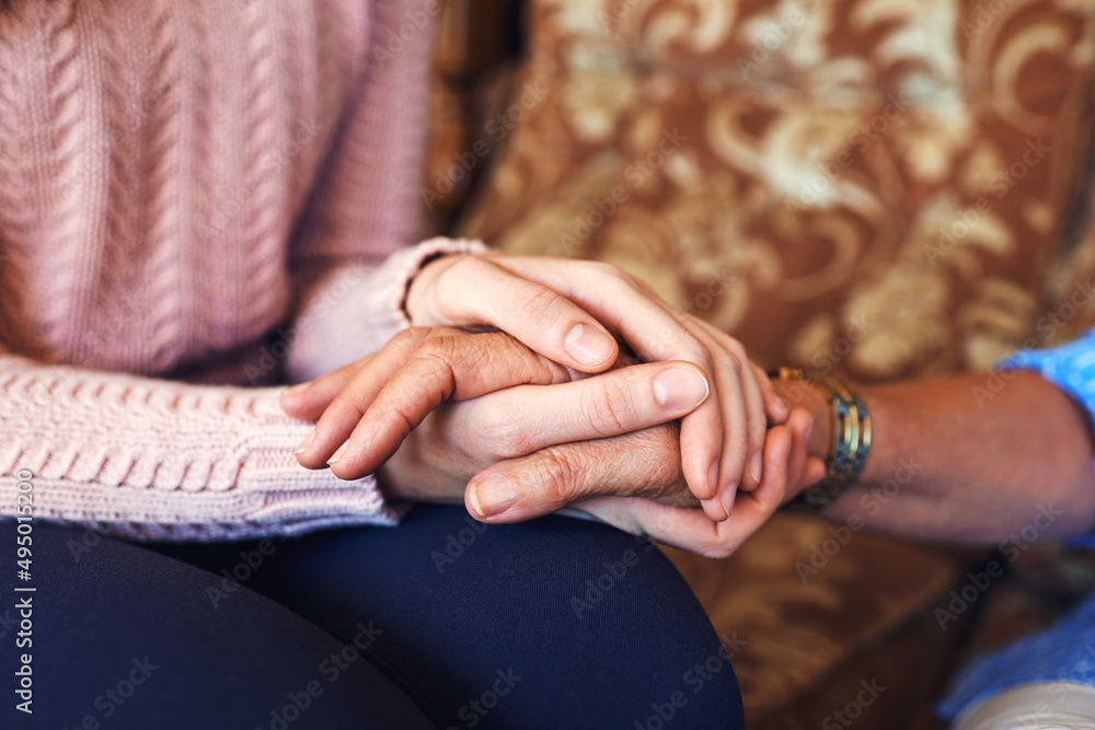 We in this together, you are not alone. Cropped shot of unrecognizable women holding hands at home.