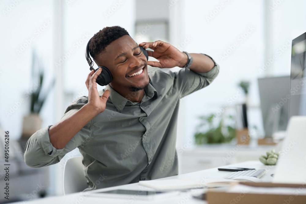 That Friday feeling. Shot of a young man on a call at work in a office.