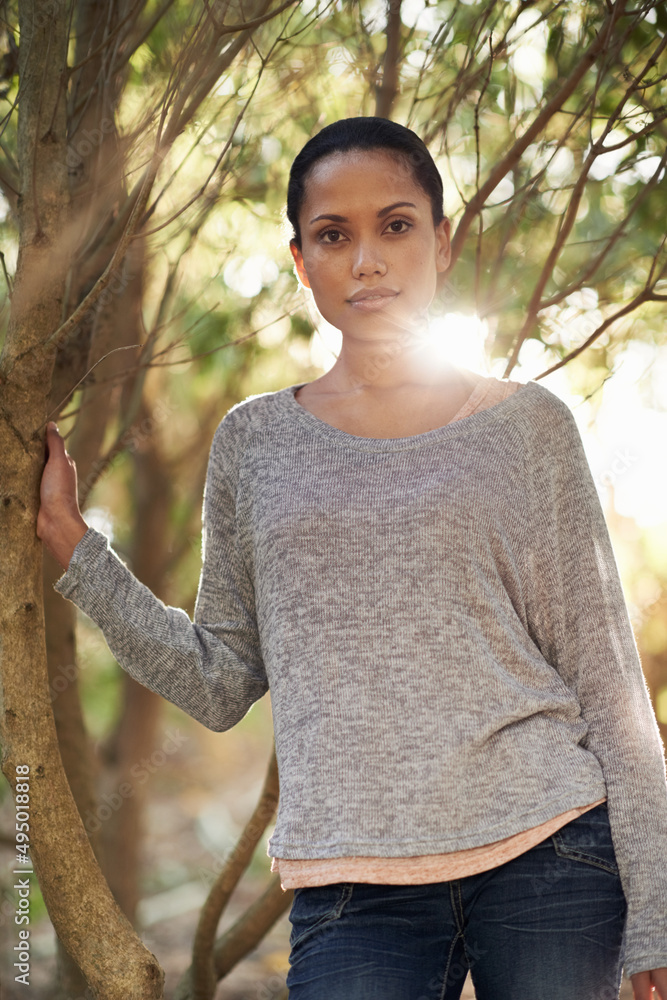 Taking in nature. A young woman enjoying a walk in the woods.