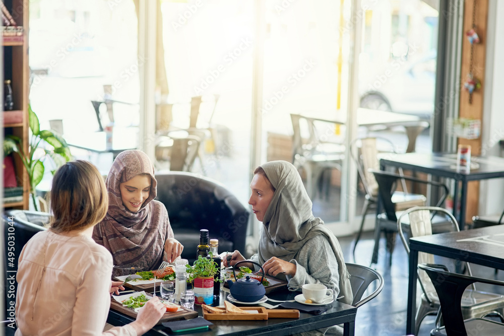 Saturday is catch up day. Shot of a group of women getting together for lunch in a cafe.