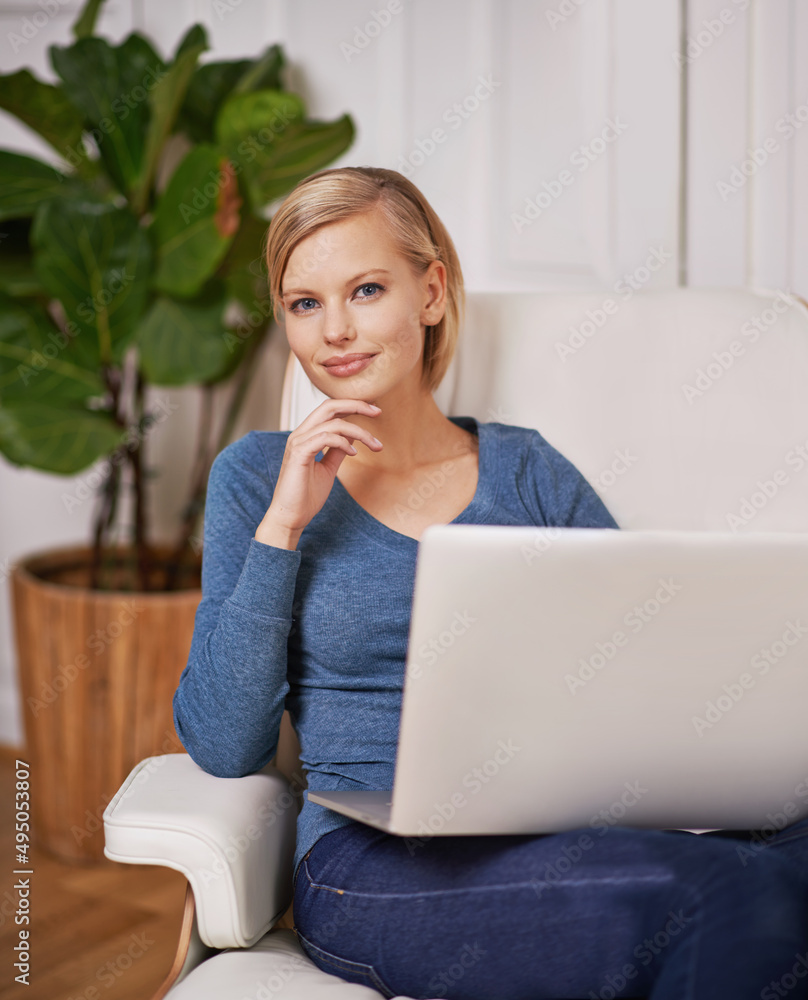 On to a new idea. Portrait of a beautiful woman sitting on a couch using a laptop.