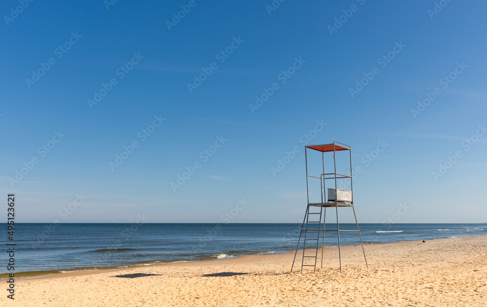 Lifeguard chair on empty sandy beach Baltic Sea Poland