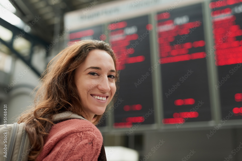 我要去度假。一个站在机场的漂亮年轻女人的后视图。