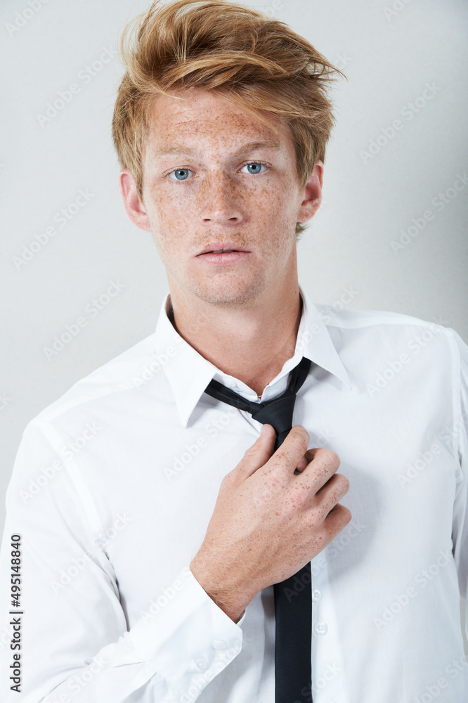 Mr Cool. Studio portrait of a young man staring at the camera.