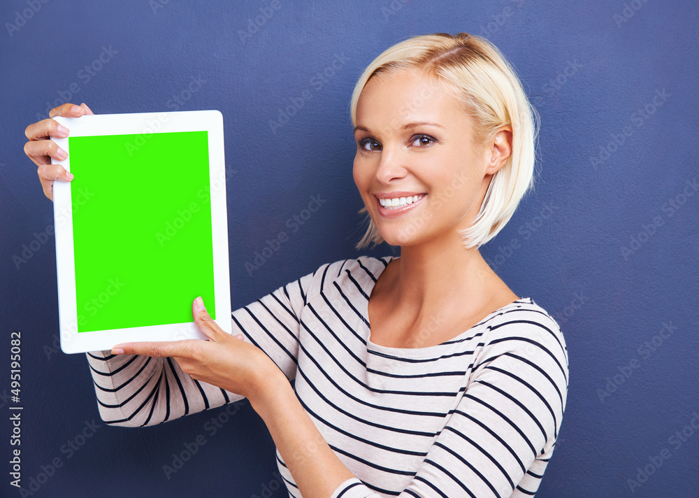 So many apps to choose from. Studio shot of a young woman holding up a digital tablet with a chroma 