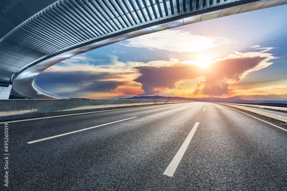 Asphalt highway and bridge with beautiful sky cloud landscape at sunset