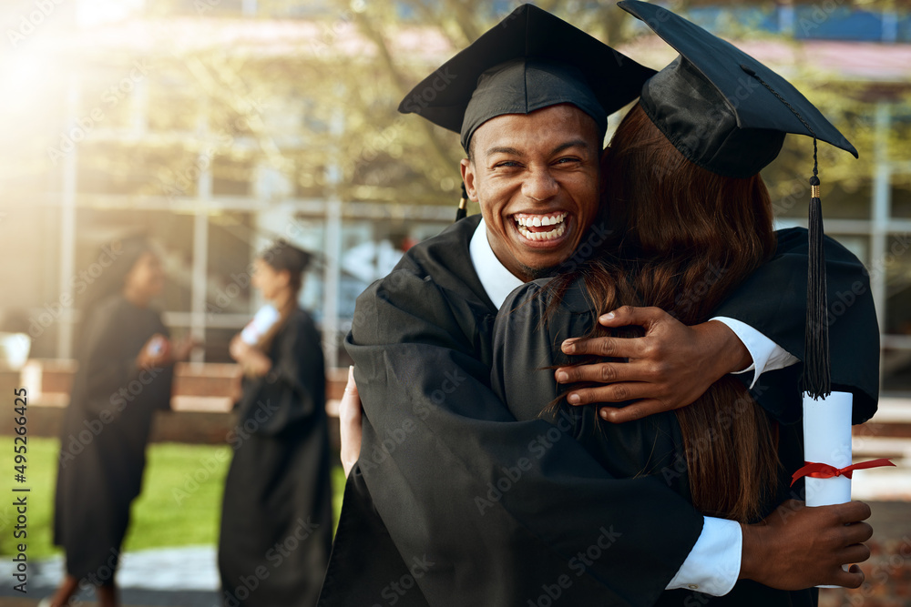 Together forever in love and education. Portrait of a happy young man and woman hugging on graduatio