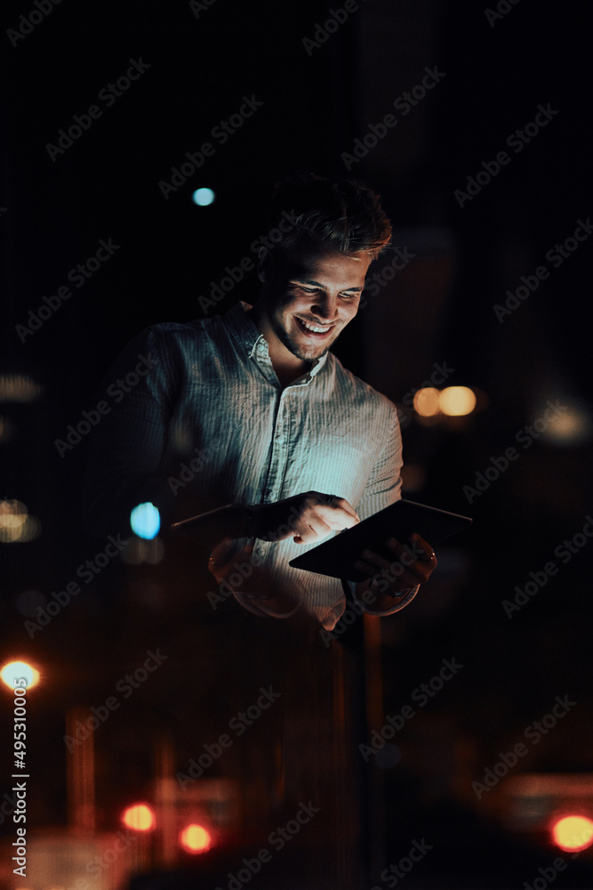 Go-getters are always in the loop. Shot of a young businessman using a digital tablet outside an off