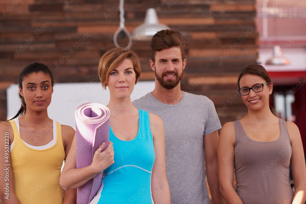 Happiness is an inside job. Shot of a group of yoga enthuisiasts looking at the camera.