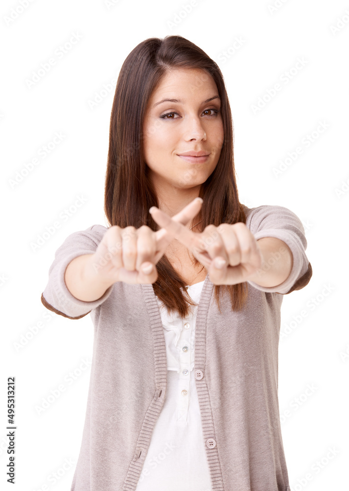 No more for me. Studio shot of a beautiful young woman making an x with her fingers against a white 