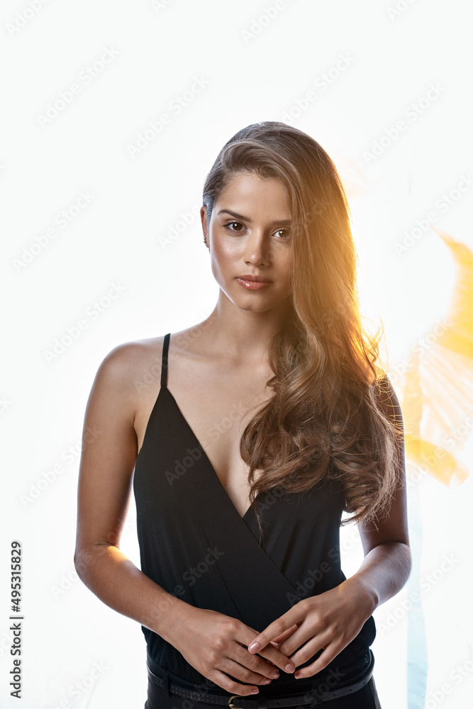 Her beauty shines bright. Studio portrait of an attractive young woman standing against a brightly l