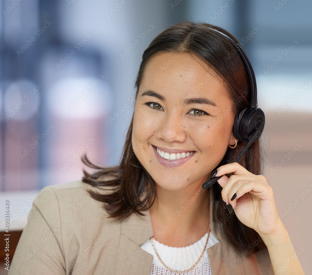 Im here to help. Portrait of a young woman using a headset in a modern office.