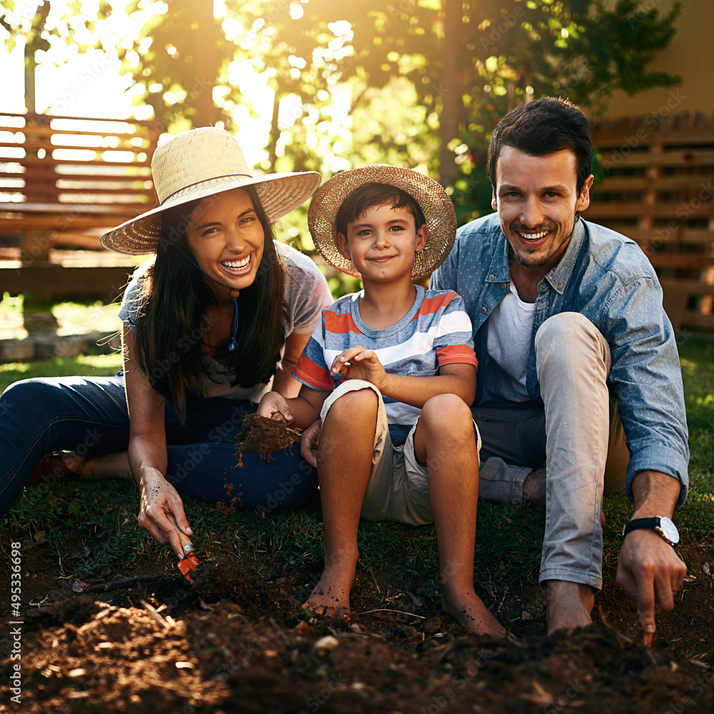 Theyre a family who love connecting with nature. Portrait of a happy family gardening together in th