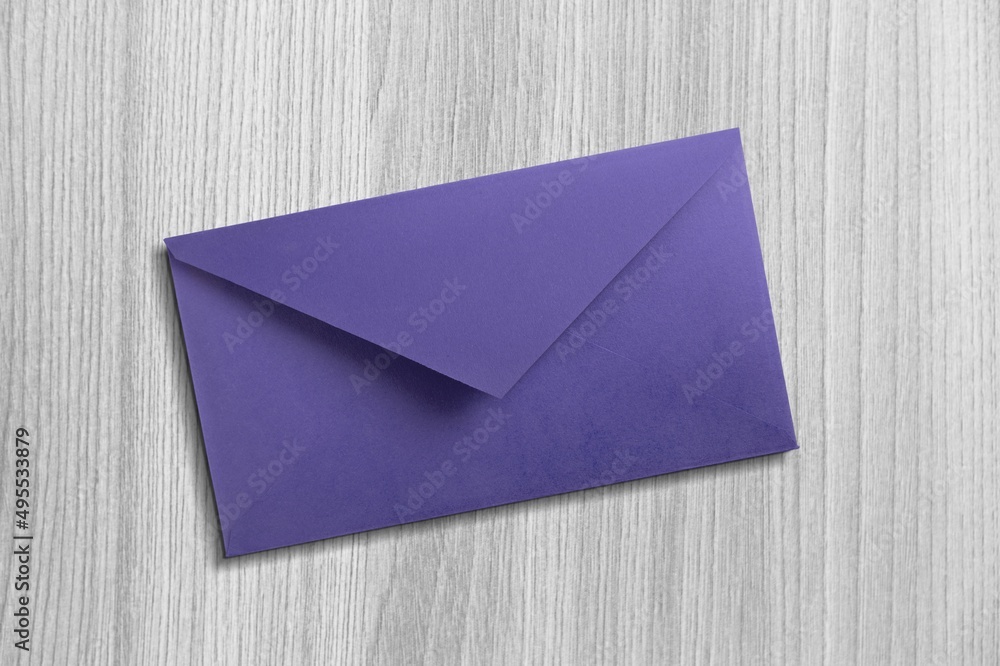 Navy envelope on desk background. Kraft paper with subtle fibers.