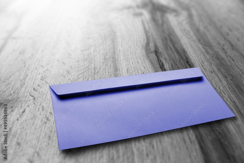 Navy violet envelope on desk. Kraft paper with subtle fibers.