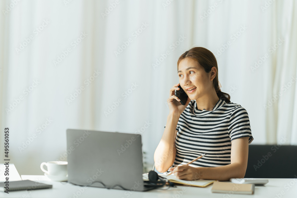 亚洲年轻快乐的女人在家里的家里使用笔记本电脑聊天