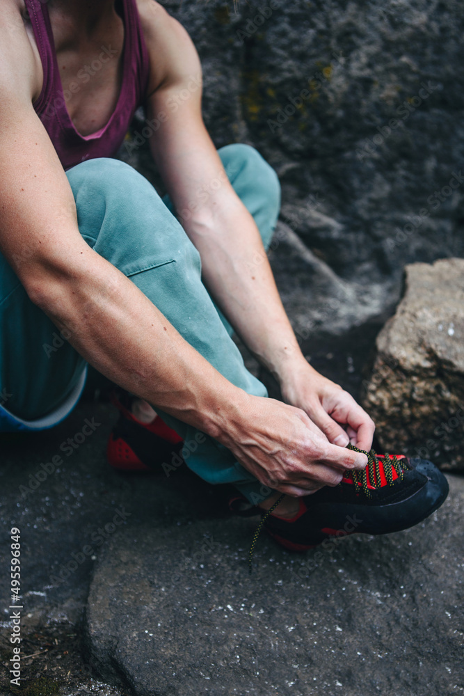 Rock climber wearing climbing shoes outdoor ready to climb