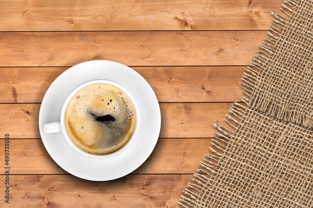 Espresso or black coffee in white cup on wooden desk