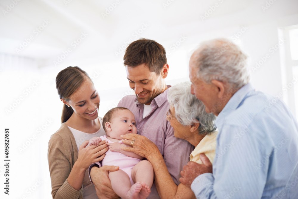 Meeting the newest addition to our family. Portrait of a smiling young couple holding their baby gir