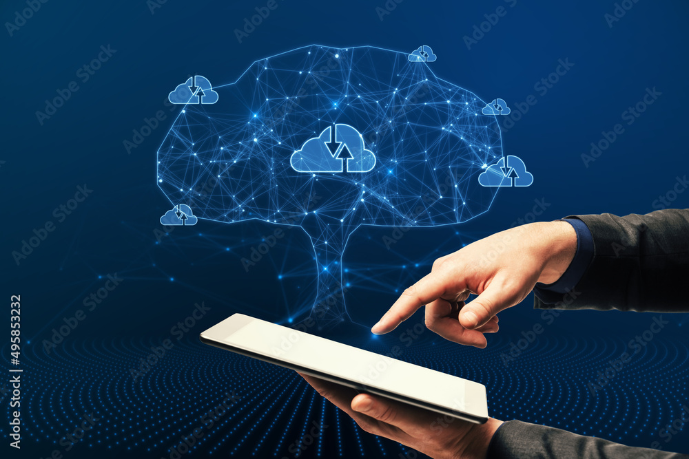 Close up of businessman hand pointing at tablet with abstract digital polygonal cloud tree on blue b