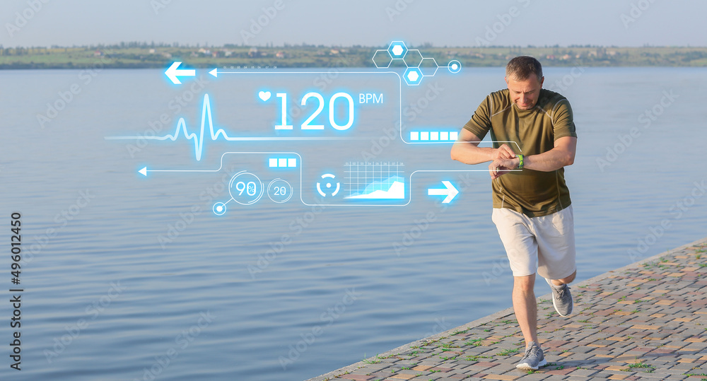 Mature man checking pulse while running near river