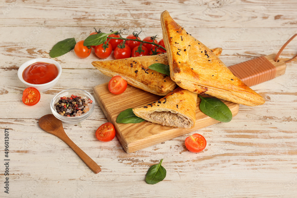 Board with tasty Uzbek samsa on white wooden background