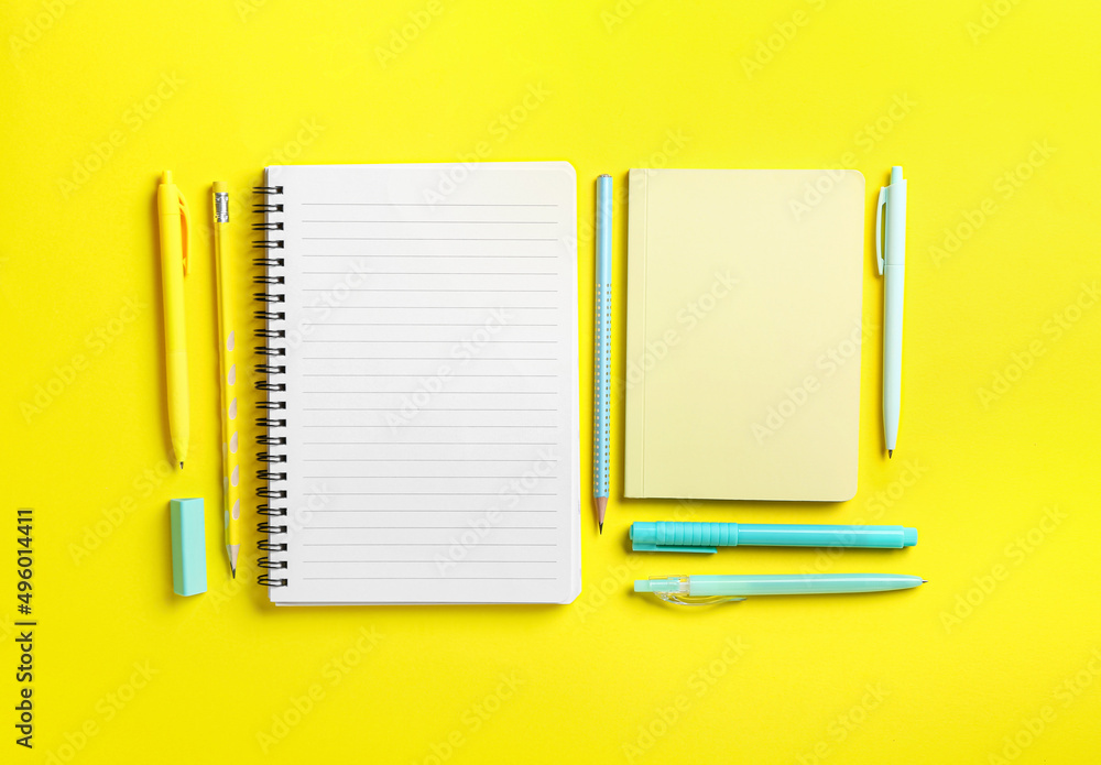 Blank notebooks and stationery on yellow background