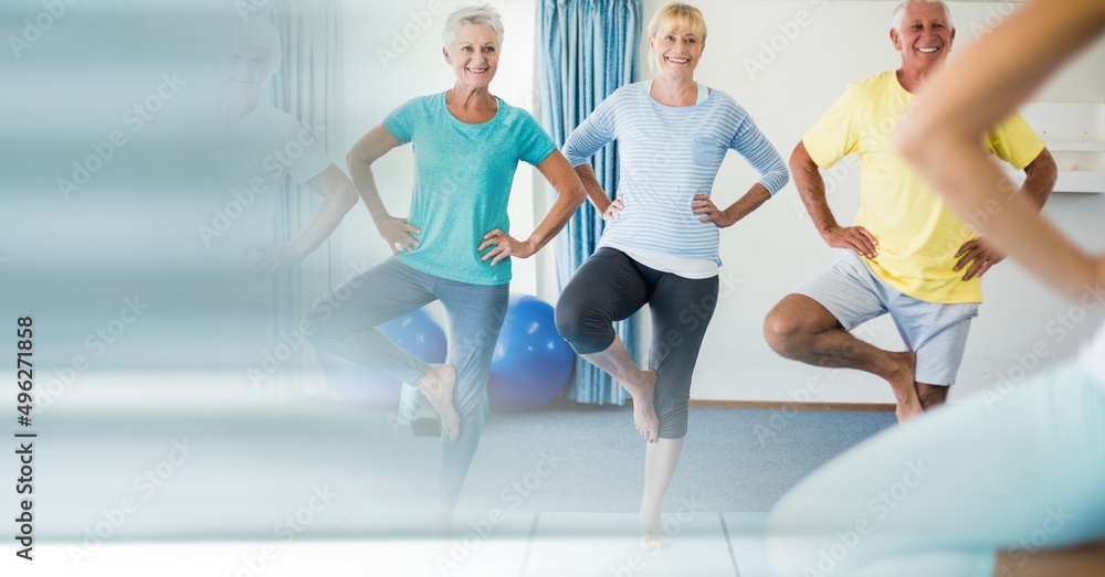 Blur effect with copy space against group of senior people performing yoga at yoga studio