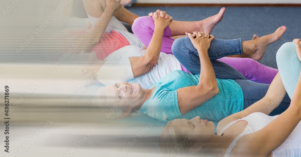 Blur effect with copy space against female yoga trainer and group of senior people performing yoga