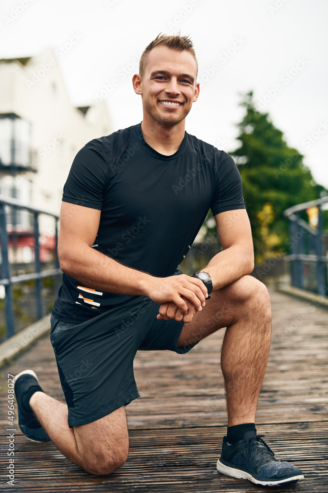 Gotta make sure my shoes are snug. Portrait of a sporty young man tying his shoelaces while exercisi