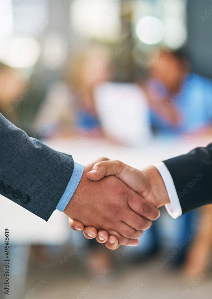 Merging together. Shot of businesspeople shaking hands.