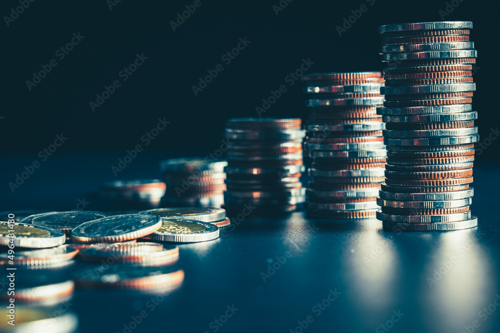 Pile of gold coins stack in finance treasury deposit bank account for saving . Concept of corporate 