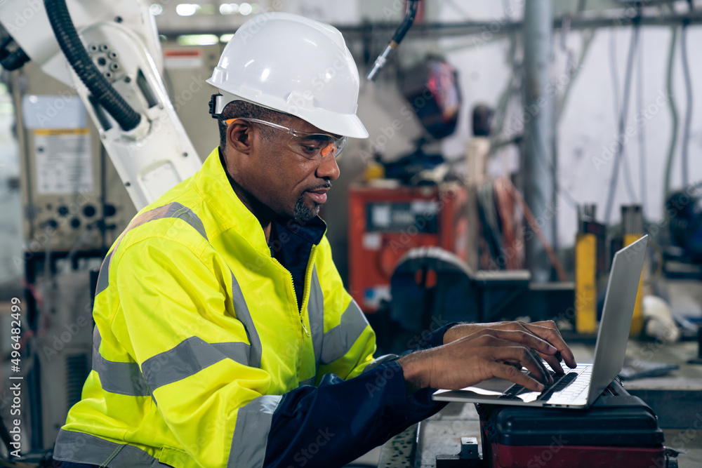 Factory worker working with laptop computer to do adept procedure checklist . Factory production lin