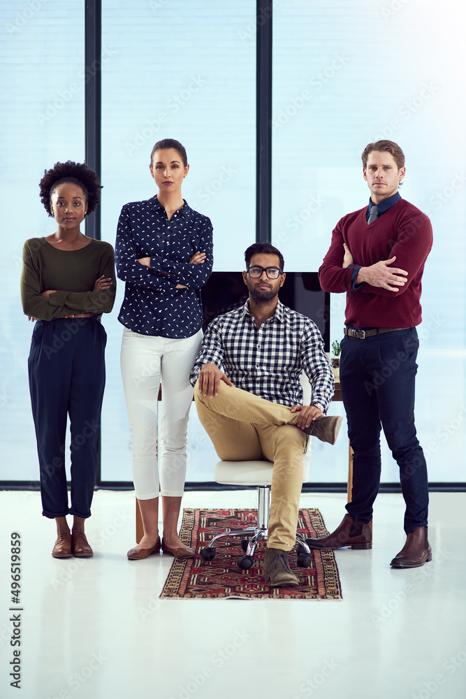 Success is theirs for the taking. Portrait of a group young designers at a work station in front of 