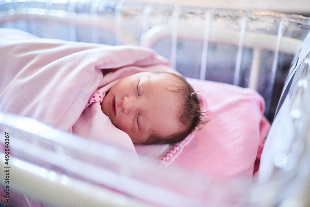 We hope all her dreams come true. Shot of a newly born baby girl wrapped in a blanket in the hospita