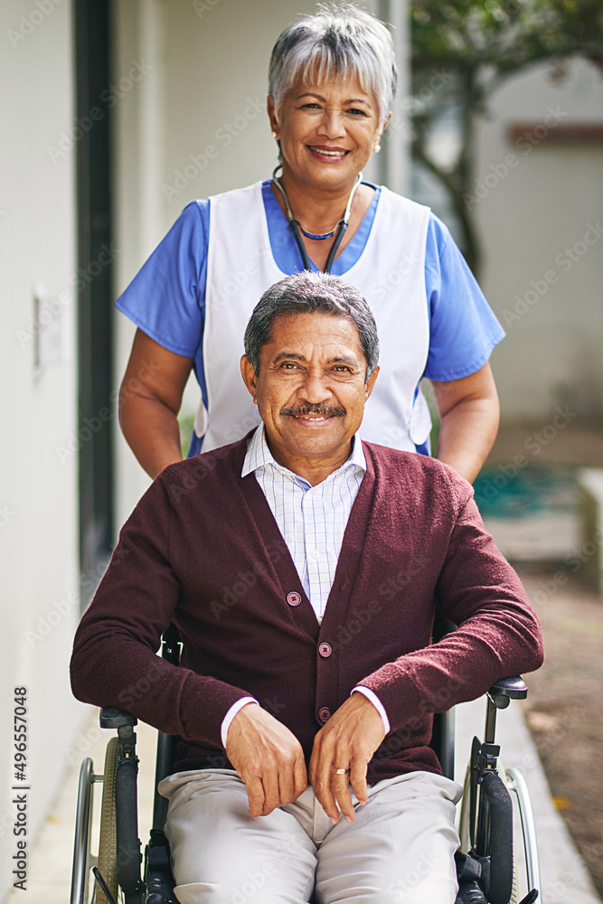 Providing assistance with a smile. Portrait of a senior man in a wheelchair being cared for by a nur