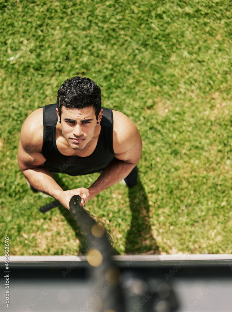 I can and I will. High angle shot of a young sportsman holding on to a rope during his workout.