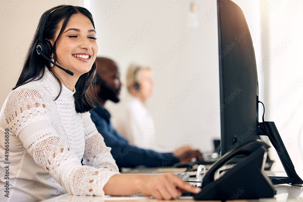 Ill call the customer right away to deliver the good news. Shot of a young call centre agent using a