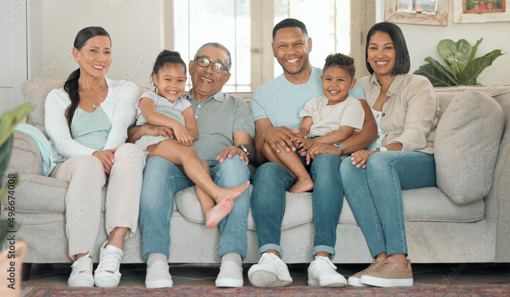 Family time is so important to us. Full length shot of a happy family sitting on the sofa at home an