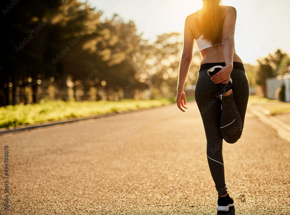 Prepare for your best run yet. Rearview shot of an unidentifiable young woman stretching before a ru