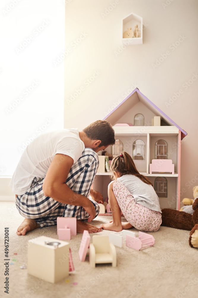 He does what she wants to do. Full length shot of a handsome young man and his daughter playing with