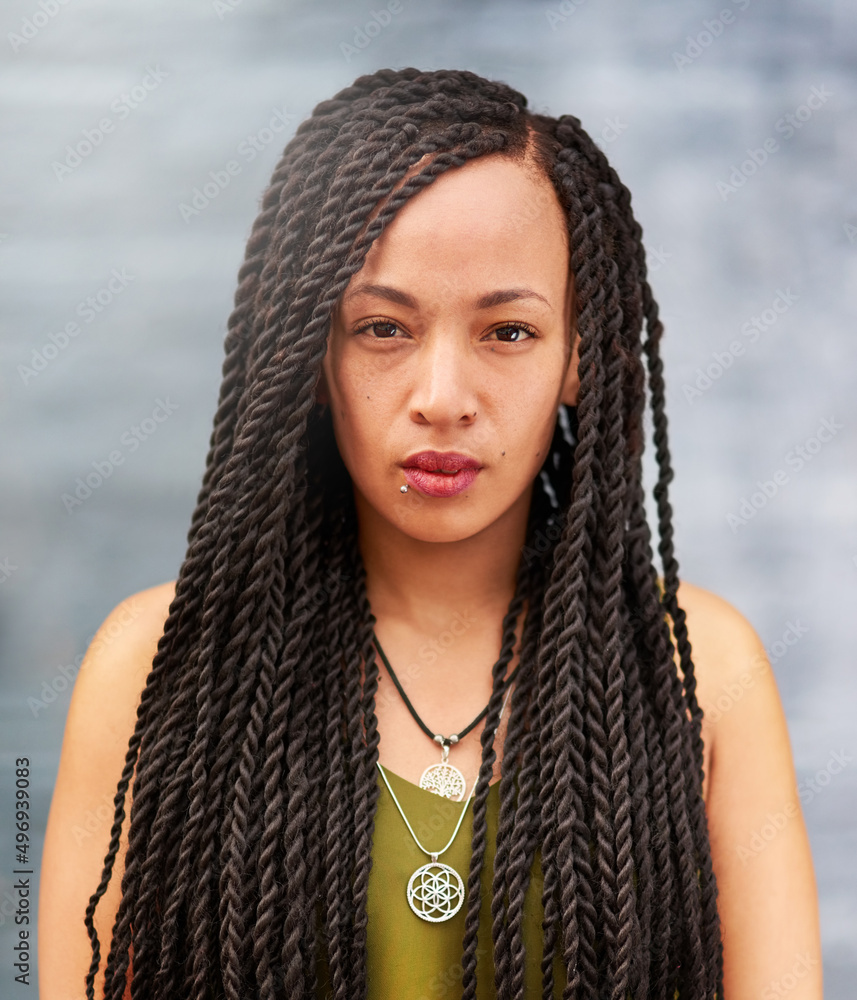 Long an beautiful braids. Portrait of an attractive young woman with beautiful braids posing outdoor