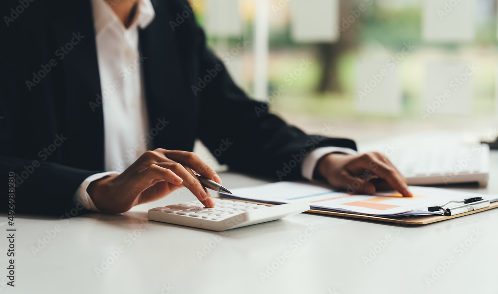 Accountant working with data documents calculating on business report.