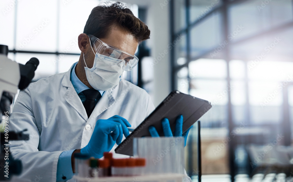 Doing tests to see what works. Cropped shot of a young male scientist working in a lab.