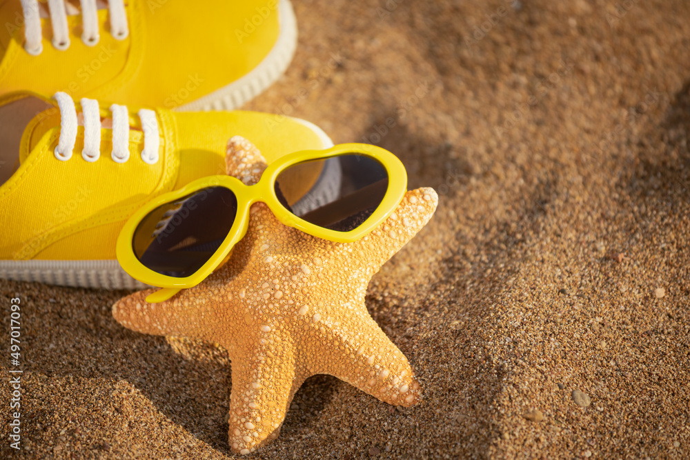 Starfish wearing sunglasses on the beach