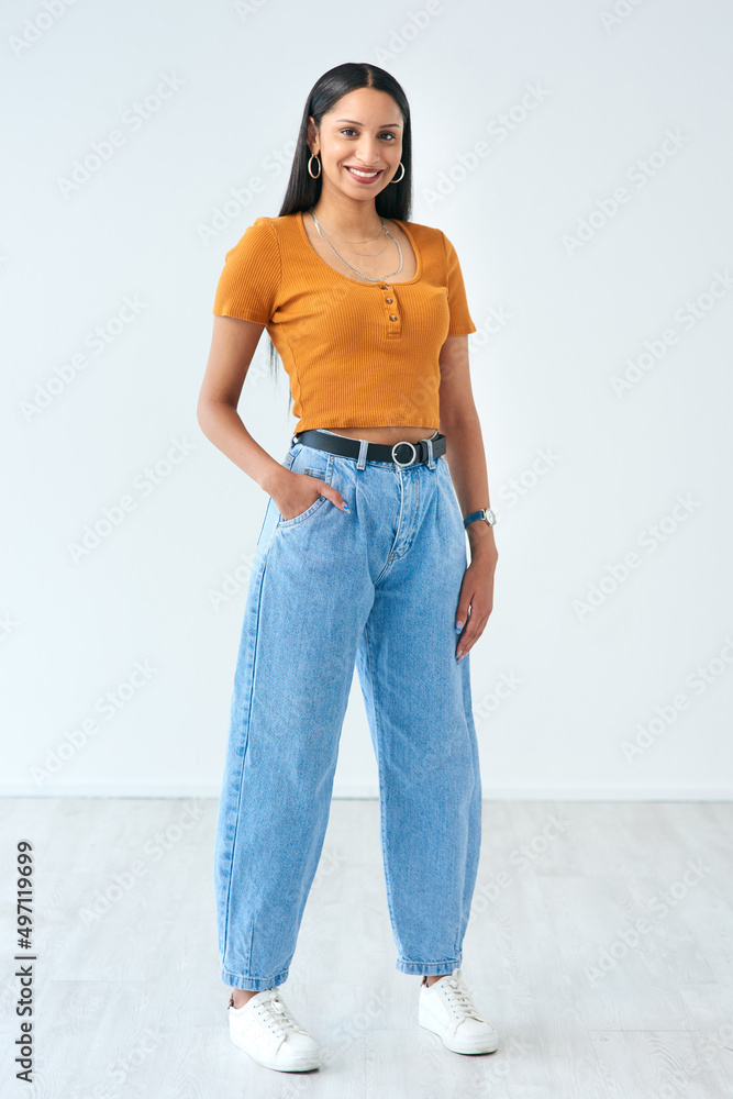 Keeping it casual. Full length portrait of an attractive young woman standing with her hand in her p