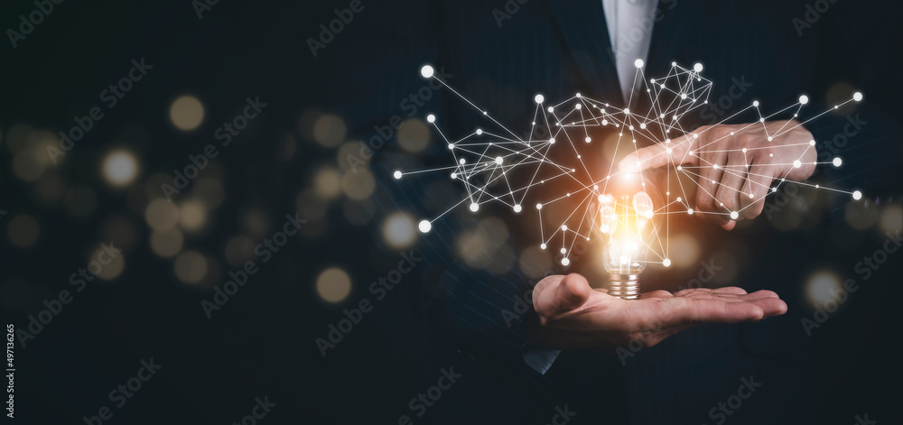 Businessman holding light bulbs, ideas of new ideas with innovative technology and creativity, conce